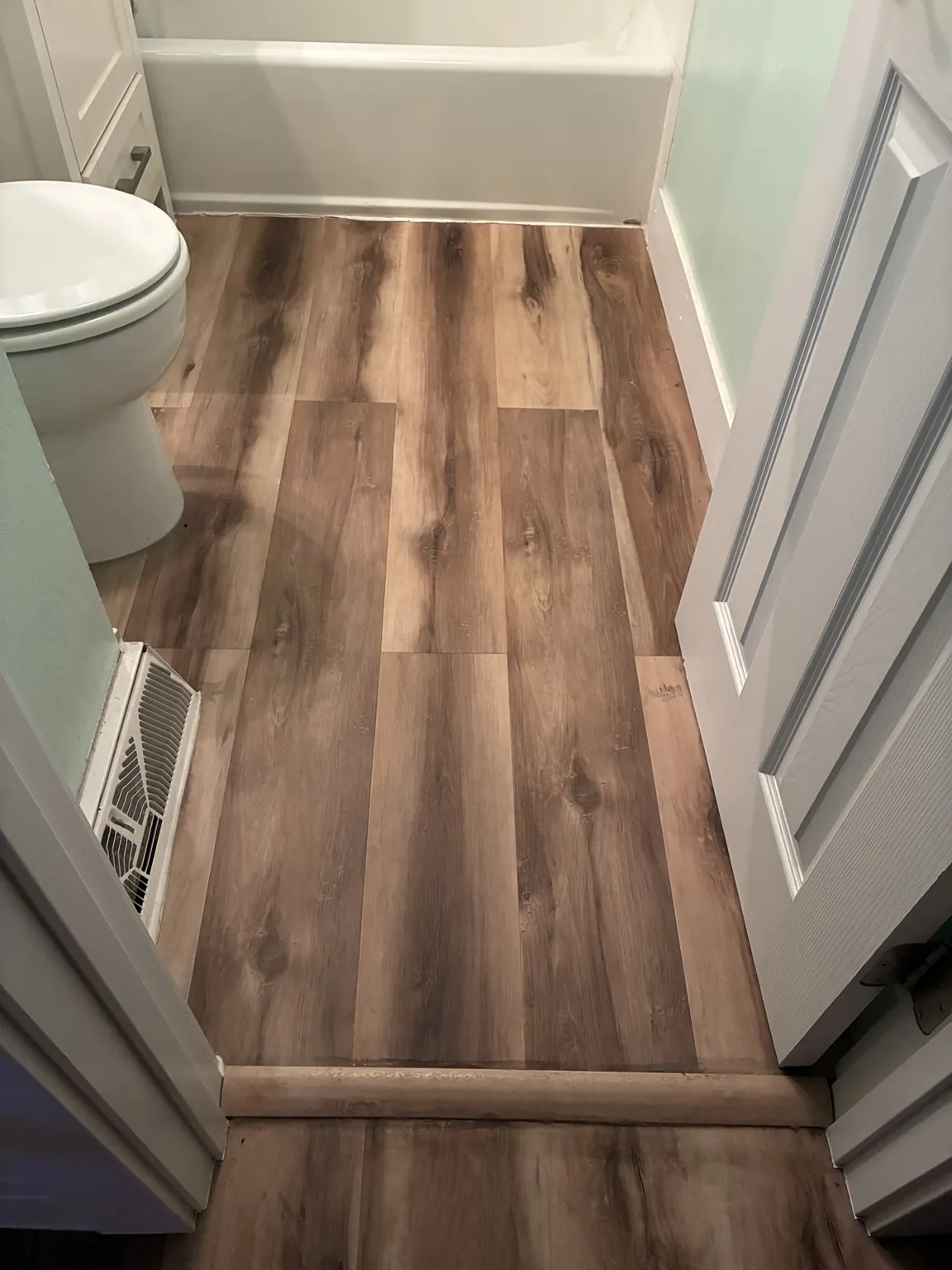 Completed bathroom flooring installation for family client Karen