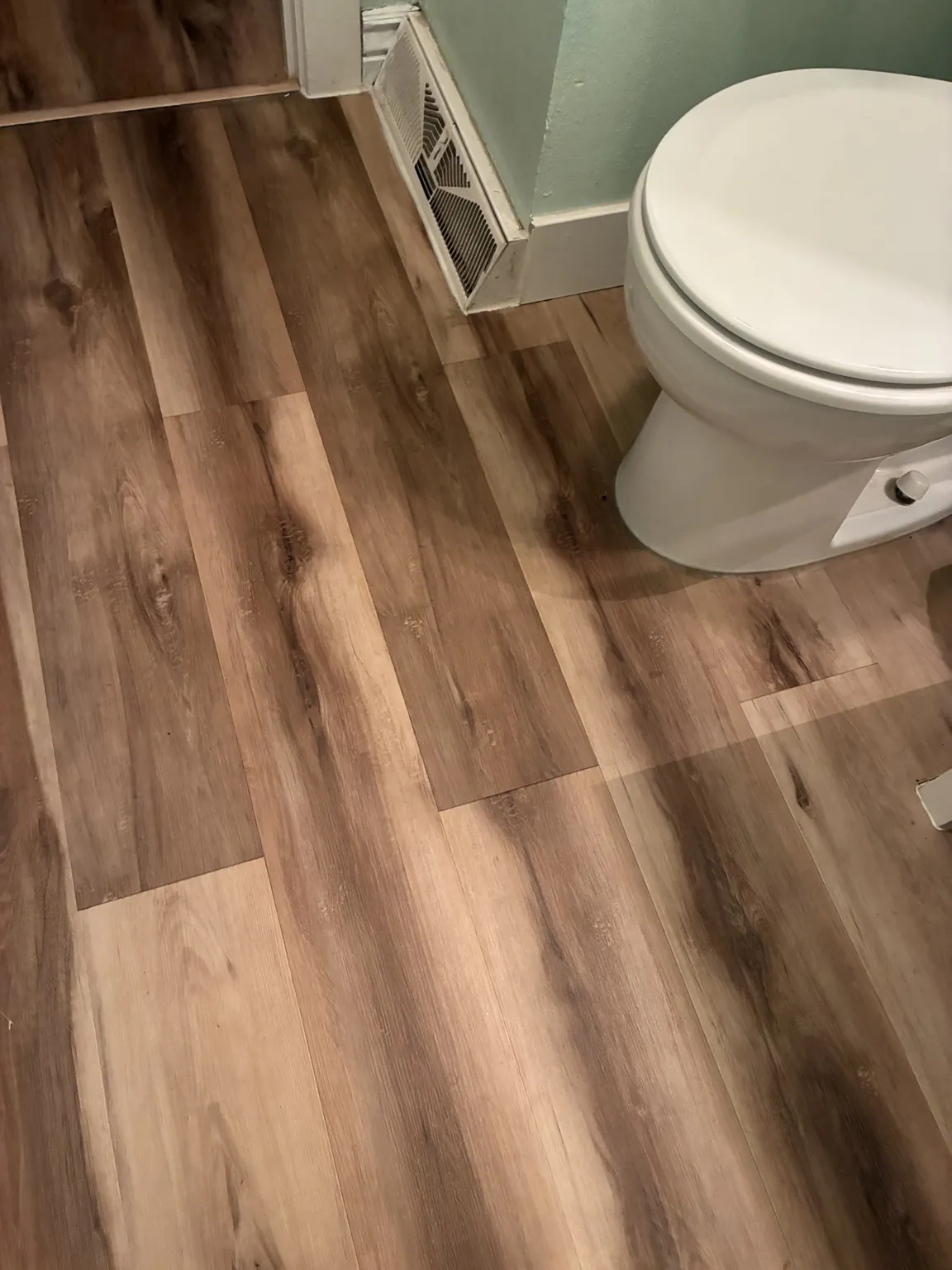 Finished bathroom flooring installation around the toilet area